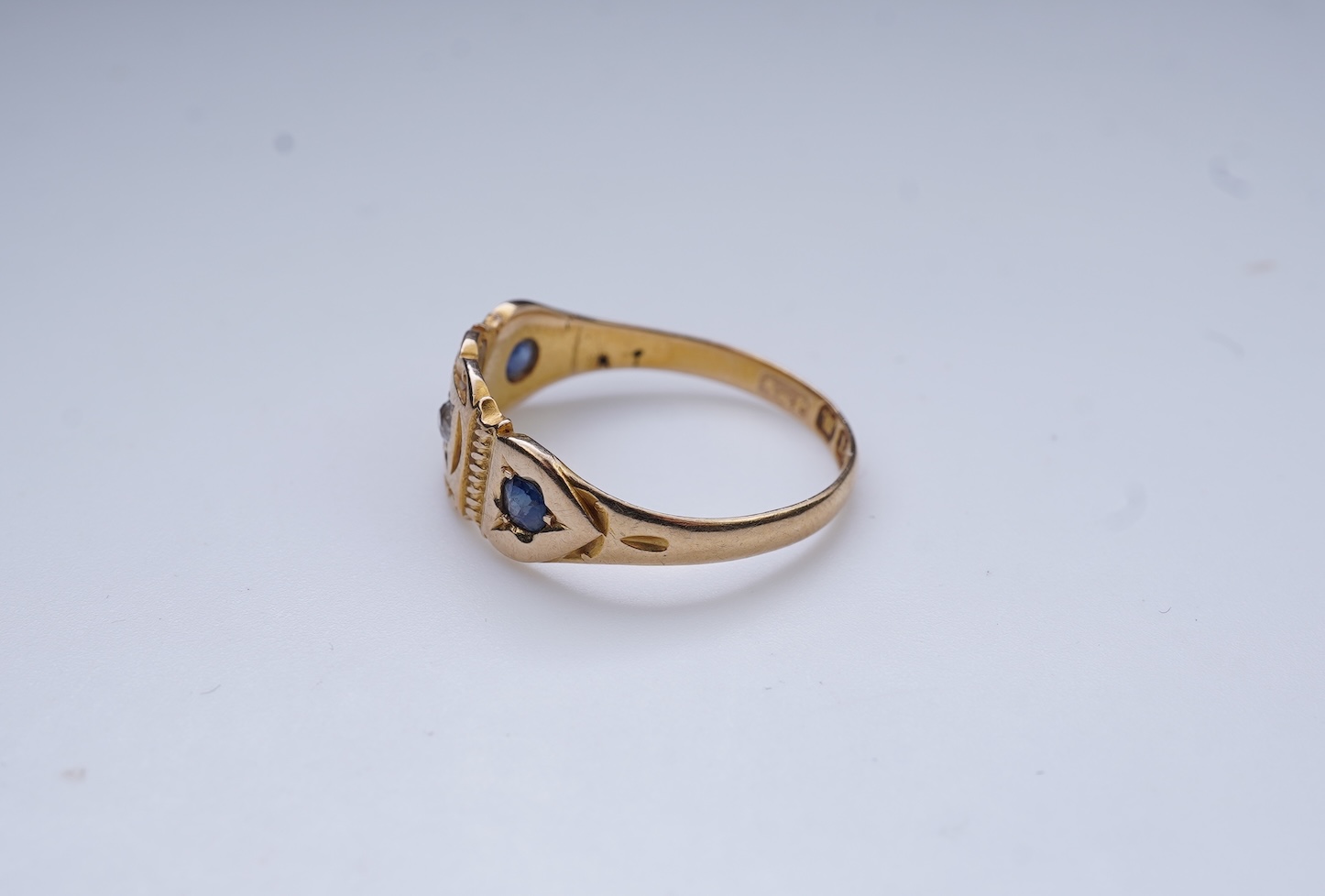 A Victorian sapphire and diamond three-stone ring, circa 1892